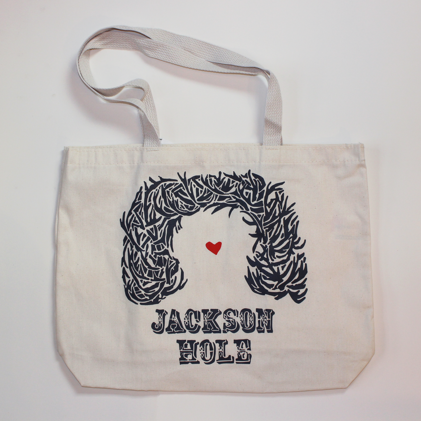 Canvas bag with screen printed antler arch design.