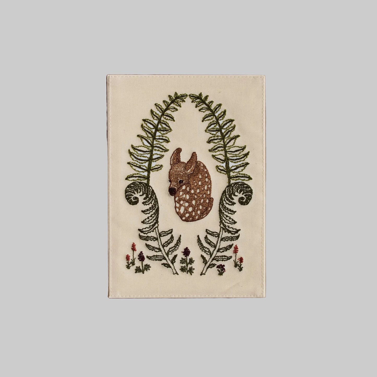 Coral and Tusk's "Fawn in Ferns" embroidered keepsake card featuring a baby deer nestled between greenery and florals