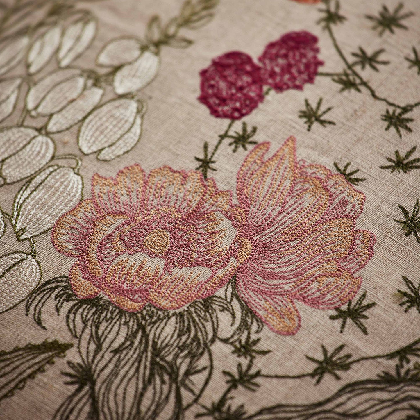 Coral and Tusk’s “Desert Blooms” embroidered linen pillow featuring vibrant colors of flowering cactus and blossoming agave, measures 20” x 20”