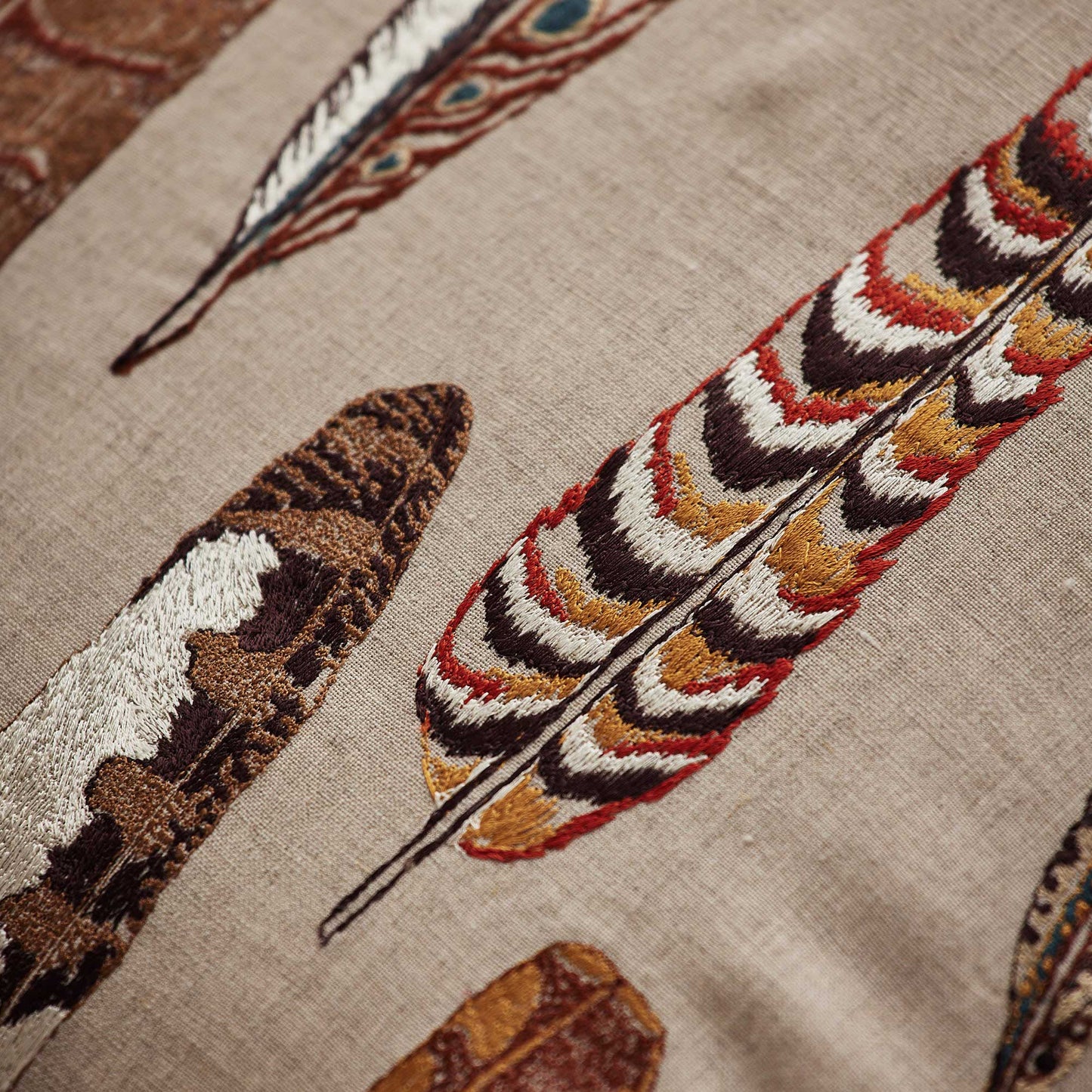 Coral and Tusk’s “Falling Feathers” embroidered linen pillow featuring large scale pheasant, kestrel and golden flicker feathers, measures 20” x 20”