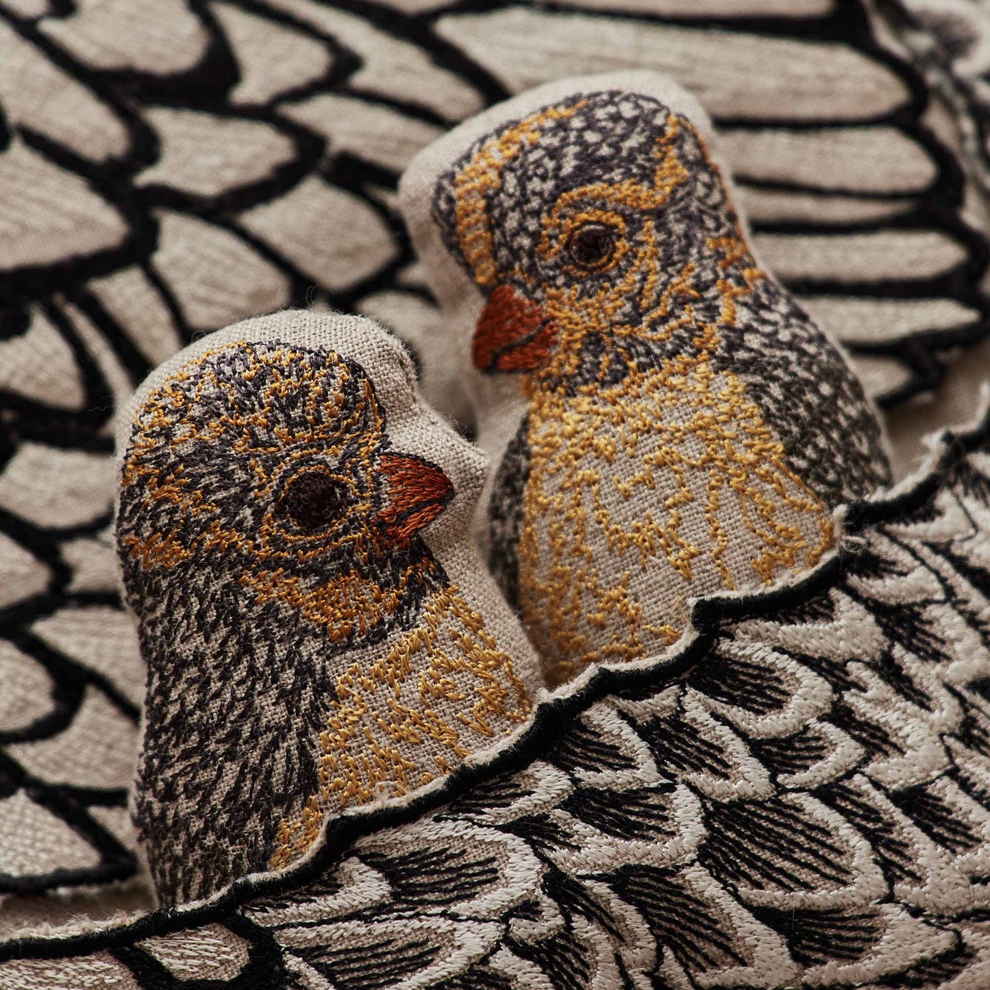 Coral and Tusk’s “Mother Hen” embroidered linen pocket pillow featuring a mother chicken with removable chicks under her wing, measures 16” x 16”