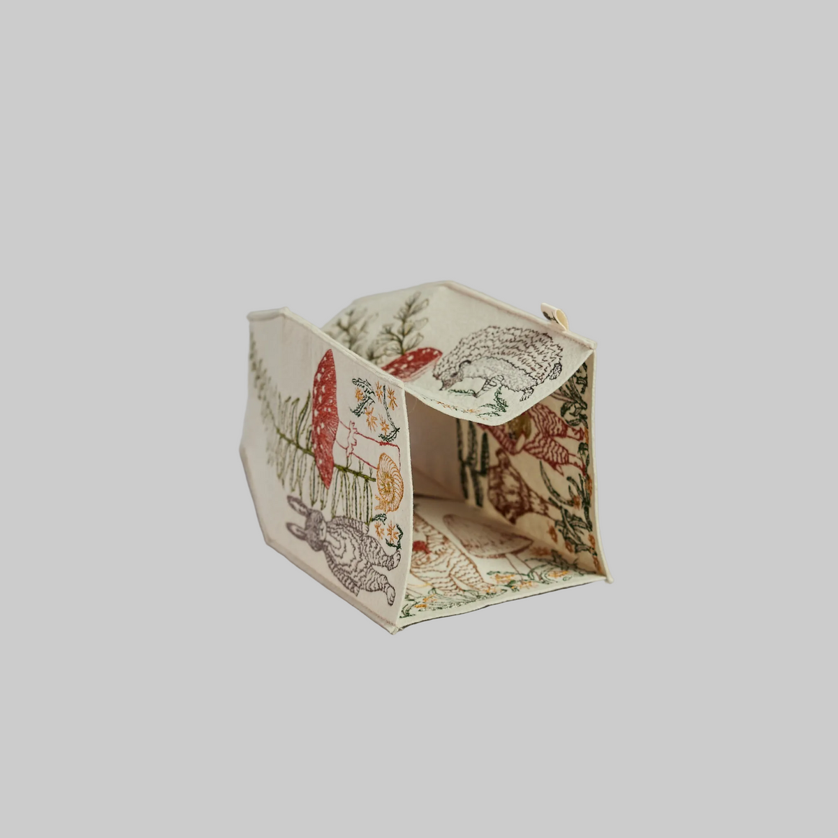 Coral and Tusk's "Mushrooms and Ferns" tissue box cover made of felt and embroidered with animal, mushroom, and fern designs