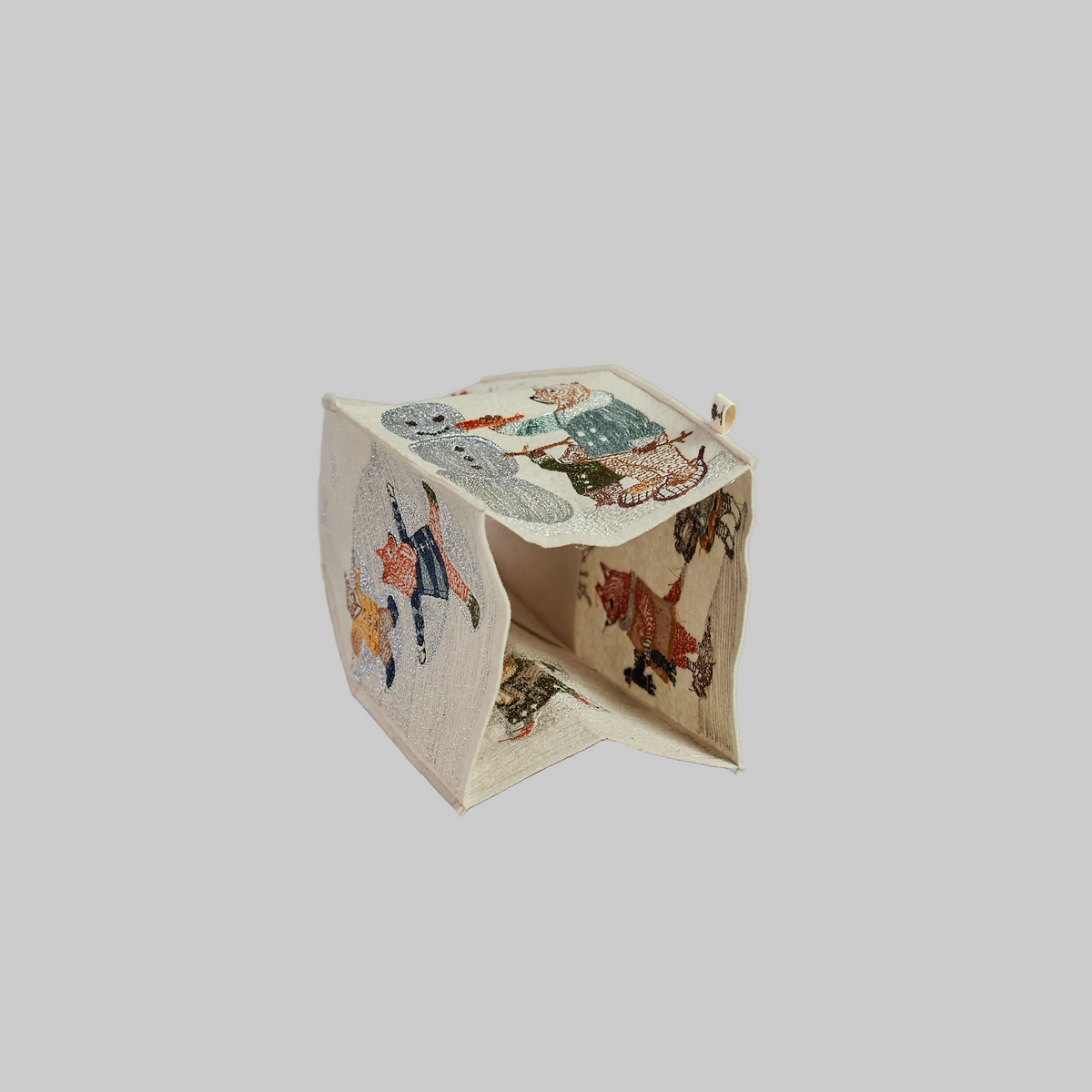 Coral and Tusk's "Snow Day" tissue box cover made of felt and embroidered with animals playing in the snow design