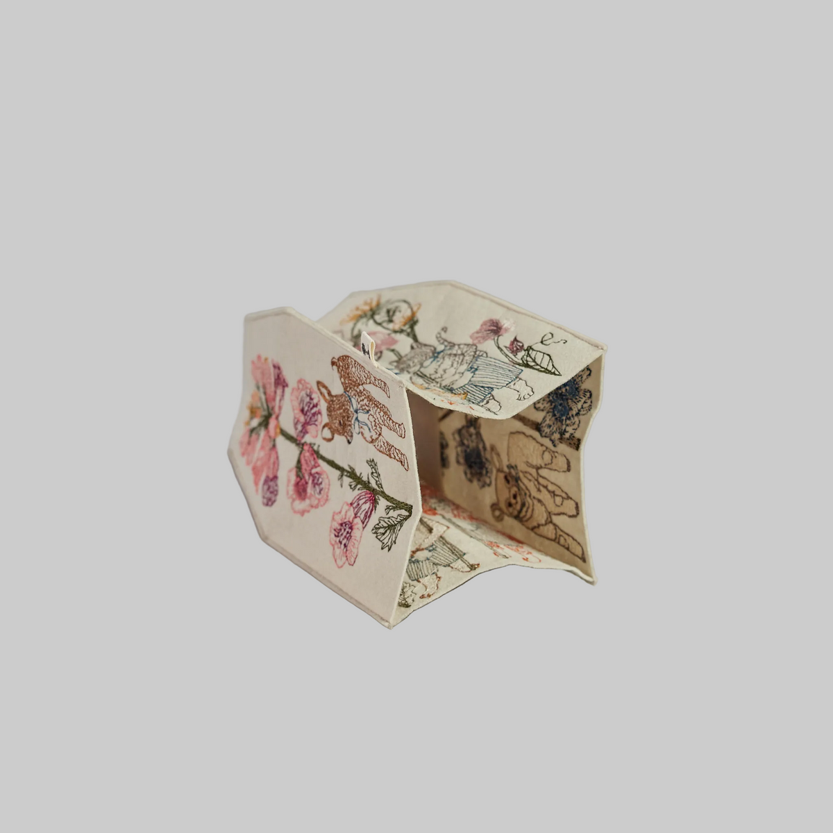 Coral and Tusk's "Spring Parade" tissue box cover made of felt and embroidered with animal and floral designs