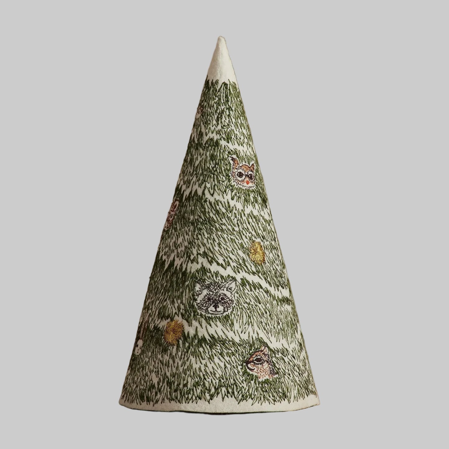 Coral and Tusk’s “Peek A Tree” felt Christmas decoration, featuring bold green stitching and woodland animals peeking through