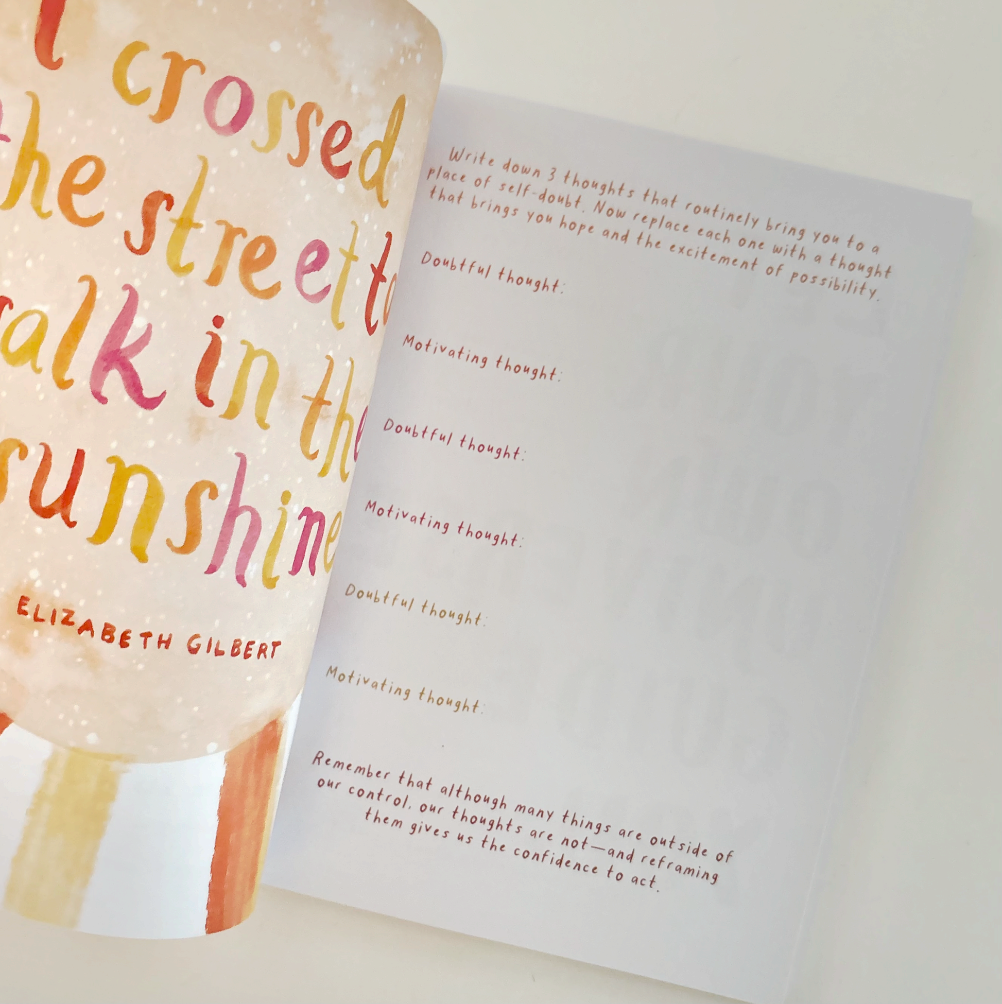 Open book with colorful text on a white background