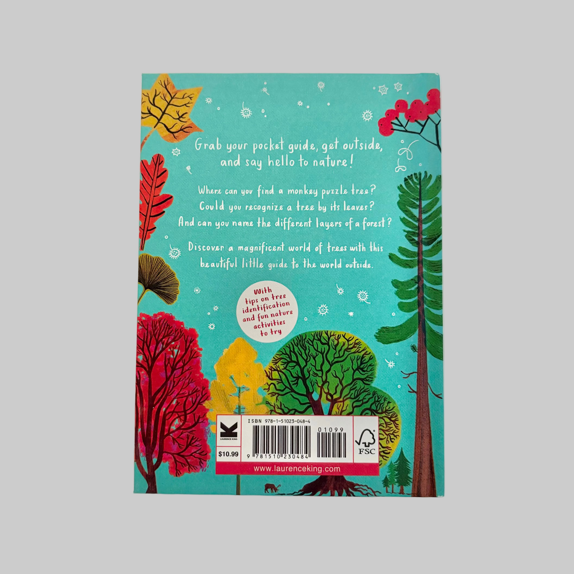 Book cover with colorful illustrations of trees on a blue background