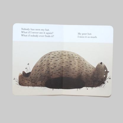 Open book with an illustration of a bear laying down