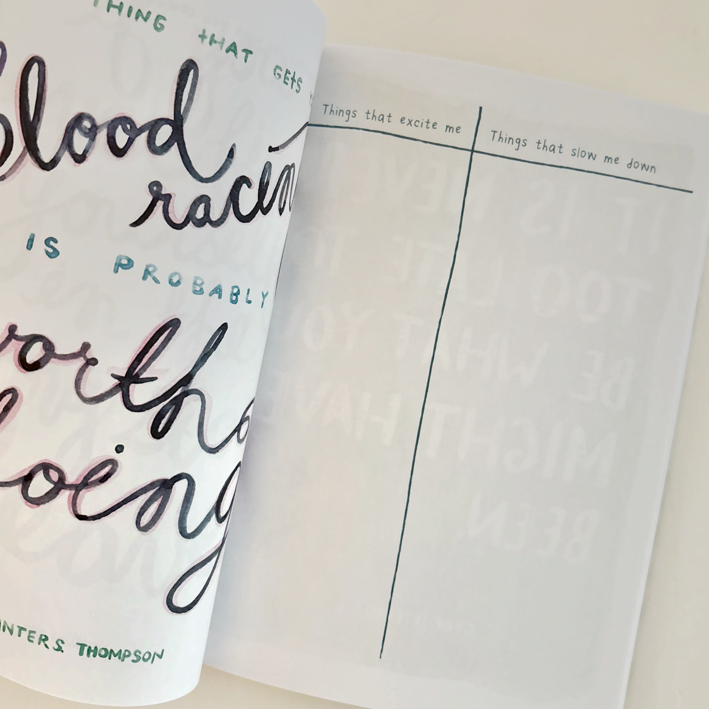 Open book with handwritten text on a white background