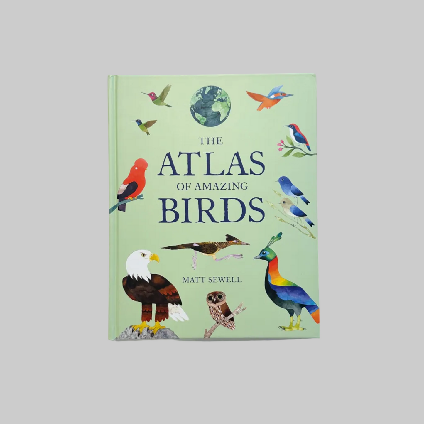 The cover of 'The Atlas of Amazing Birds' book by Matt Sewell featuring a variety of illustrated birds against a green background.