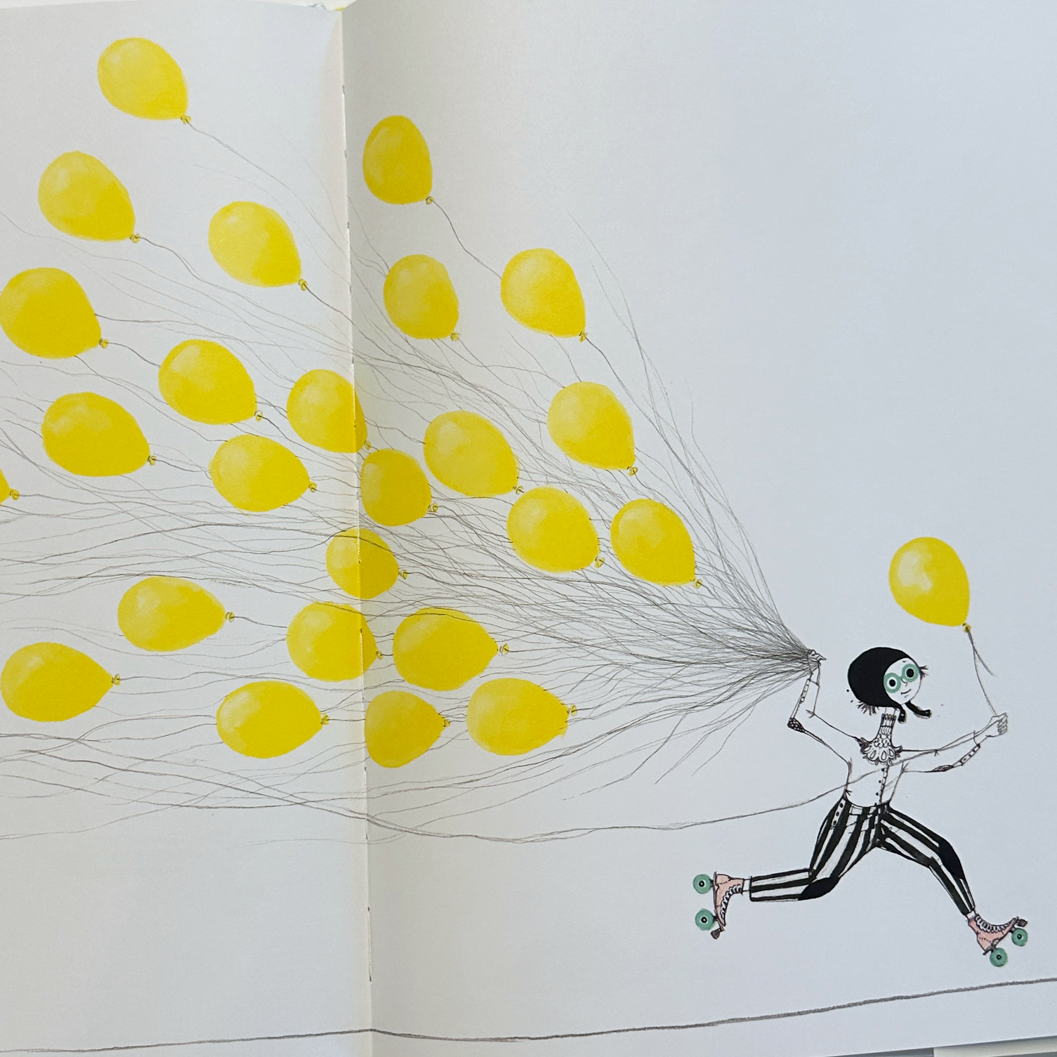 Open book with illustration of a person running while carrying yellow balloons