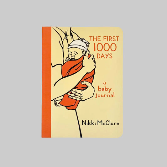 Book titled 'The First 1000 Days: A Baby Journal' by Nikki McClure.