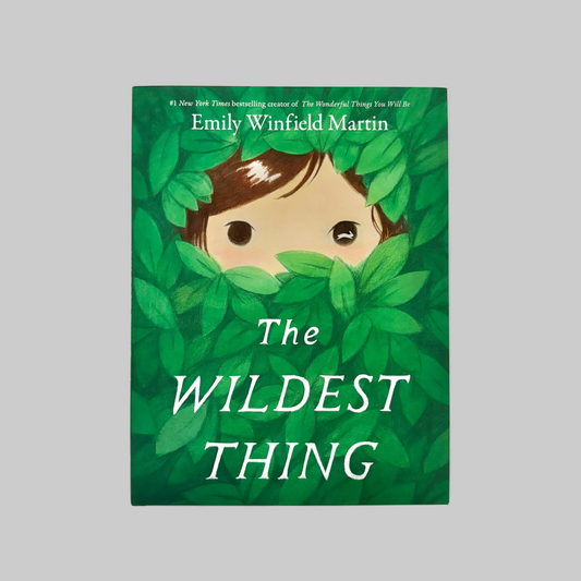 Book cover of 'The Wildest Thing' by Emily Winfield Martin with a child peeking through leaves.