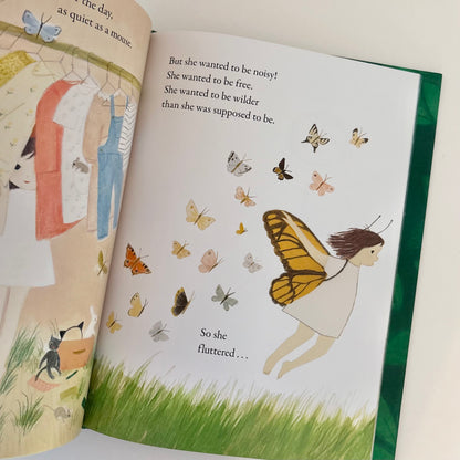 Illustrated book open to a page with a girl in butterfly wings and various butterflies.