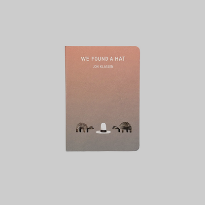 Children's book cover for 'We Found A Hat' by Jon Klassen featuring an illustration of two turtles and a hat.