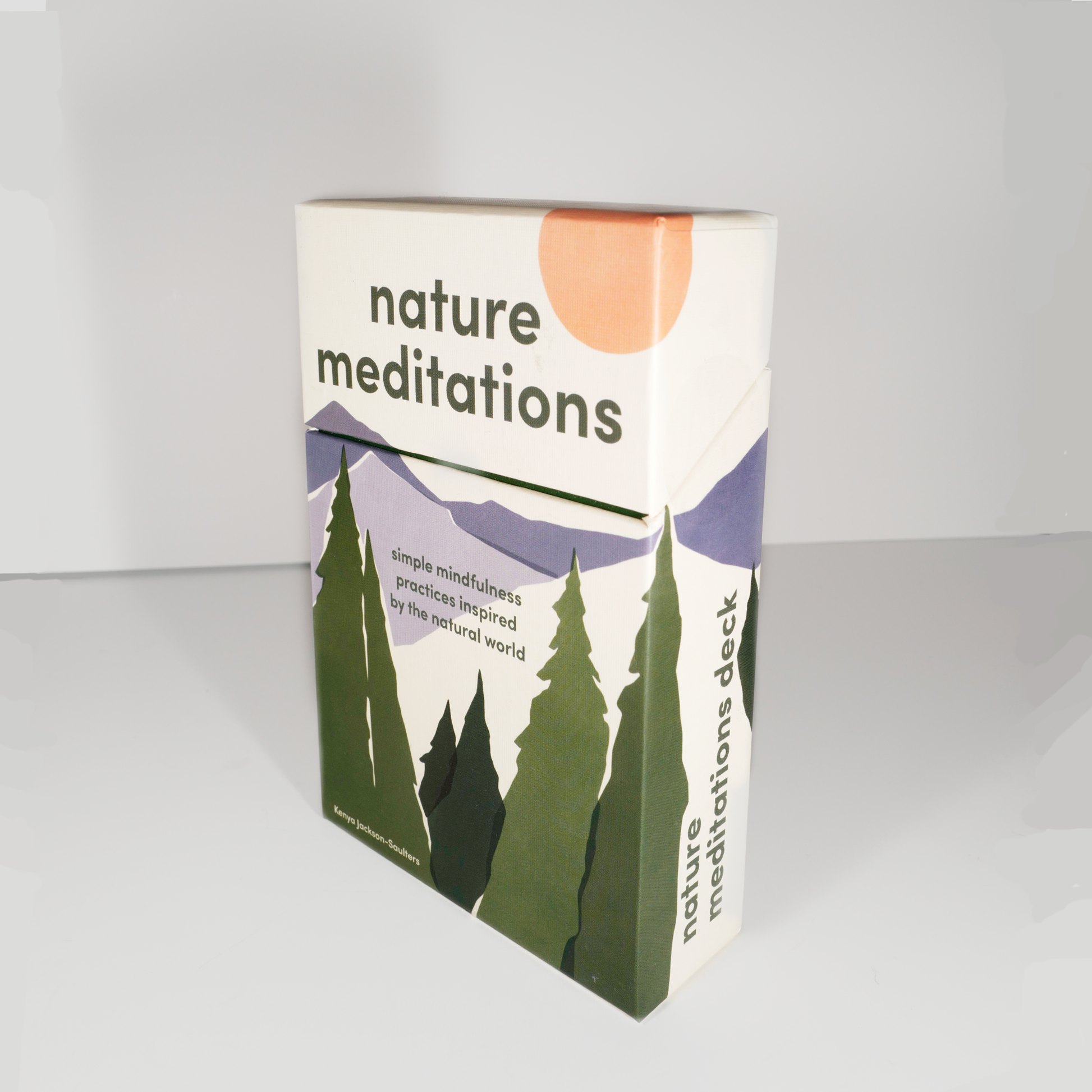 A boxed deck of cards labeled 'Nature Meditations' with a mountain and pine tree illustration on the cover.