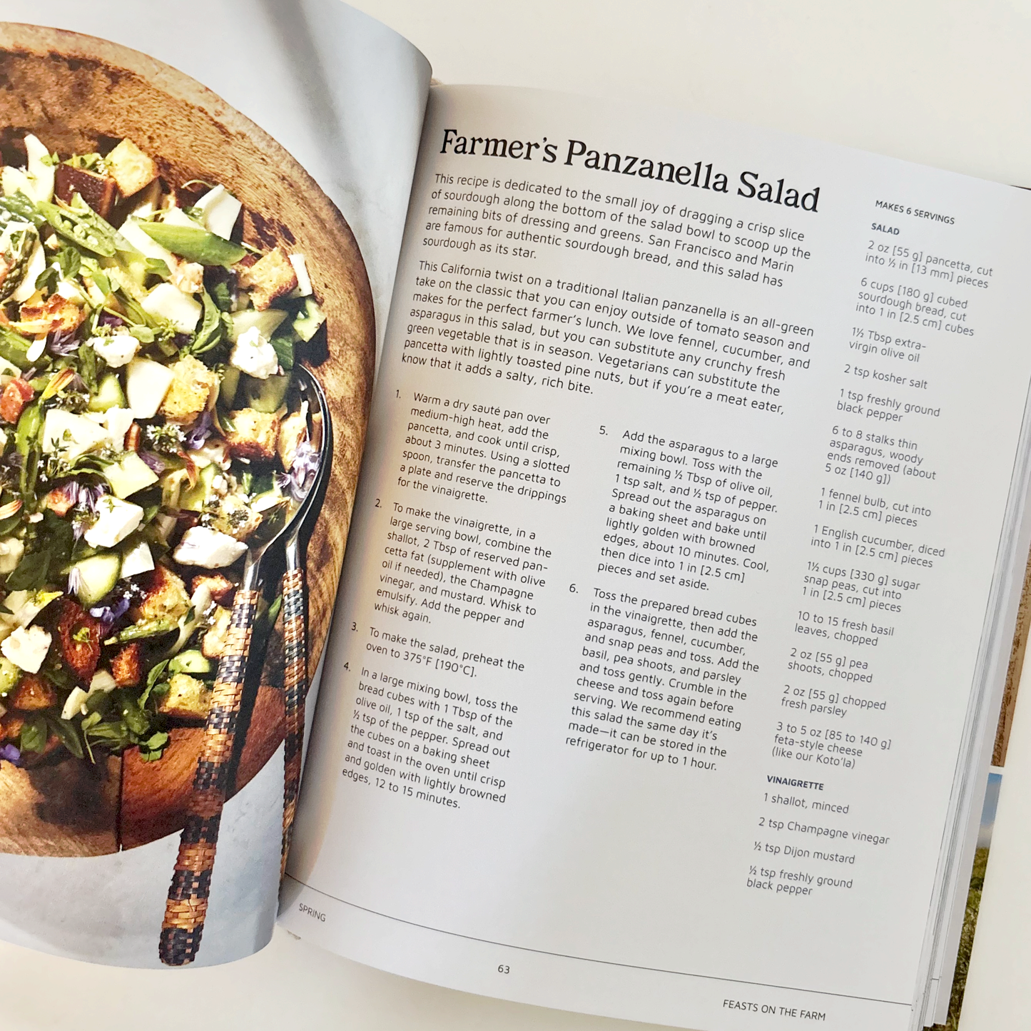 Open cookbook showing a recipe for Farmer's Panzanella Salad with an image of the salad on a plate.
