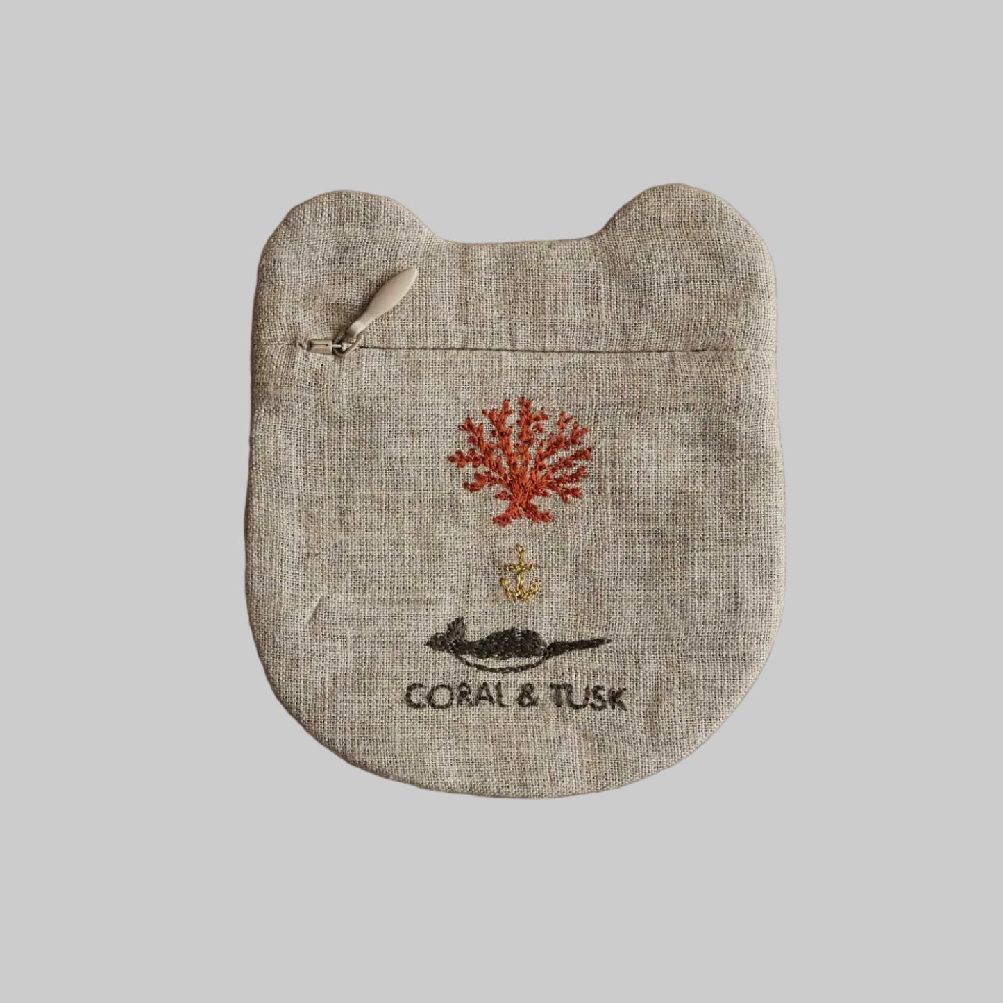Linen pouch with coral and tusk design on a beige background
