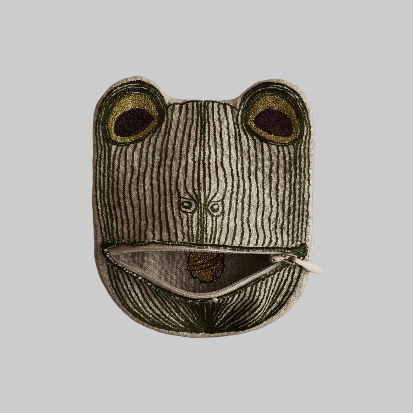 Frog-shaped pouch with a zipper on a beige background