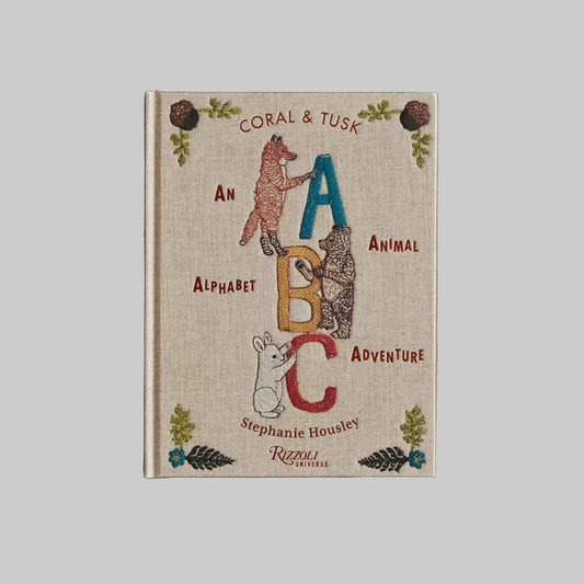 Book titled 'Coral & Tusk: An Alphabet Animal Adventure' by Stephanie Housley on a beige background