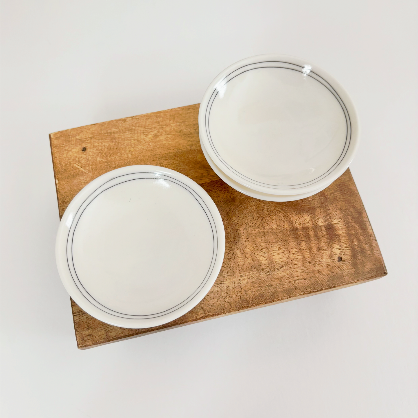 Two white ceramic dishes with black line designs made by Jenny Dowd