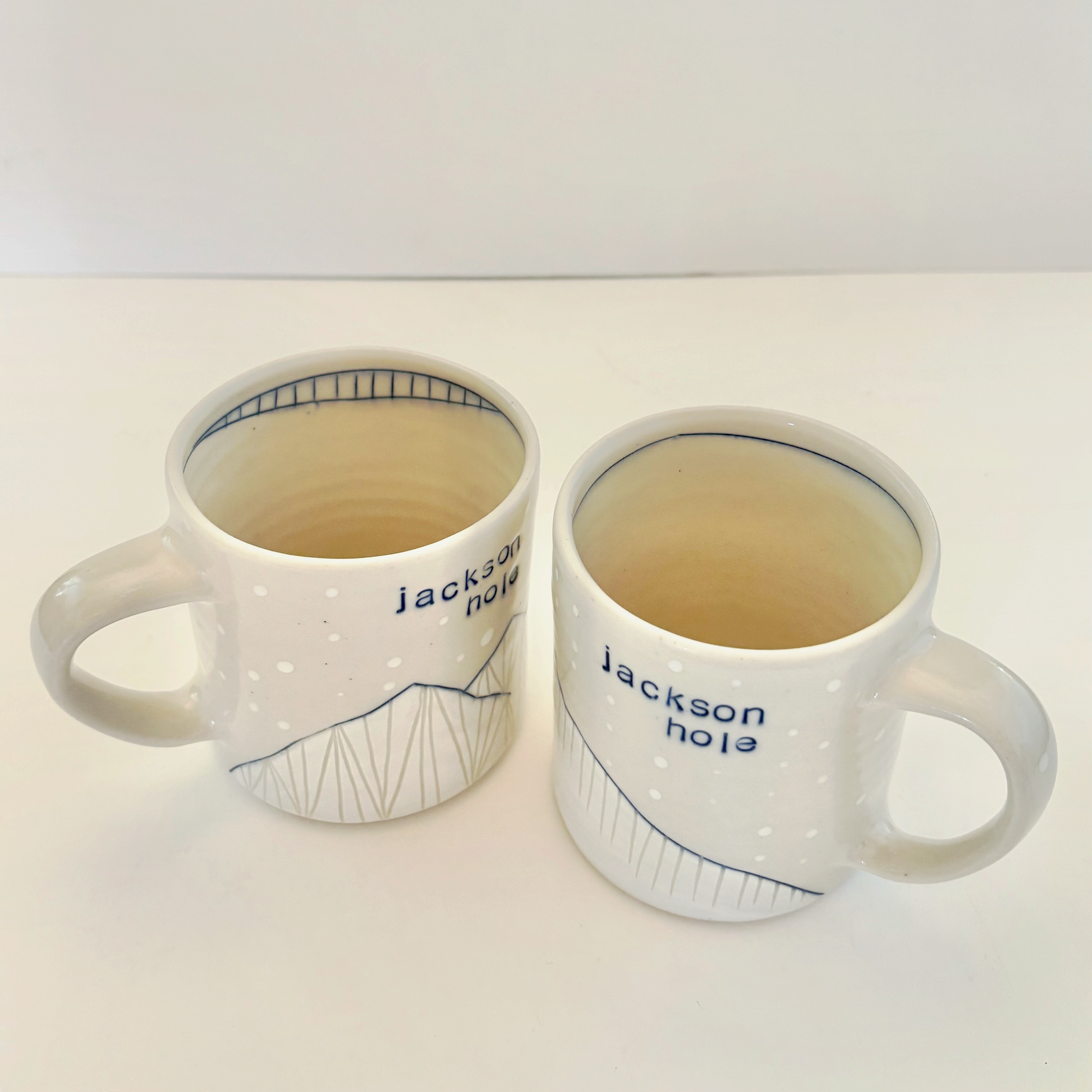 Two white mugs with 'Jackson Hole' branding