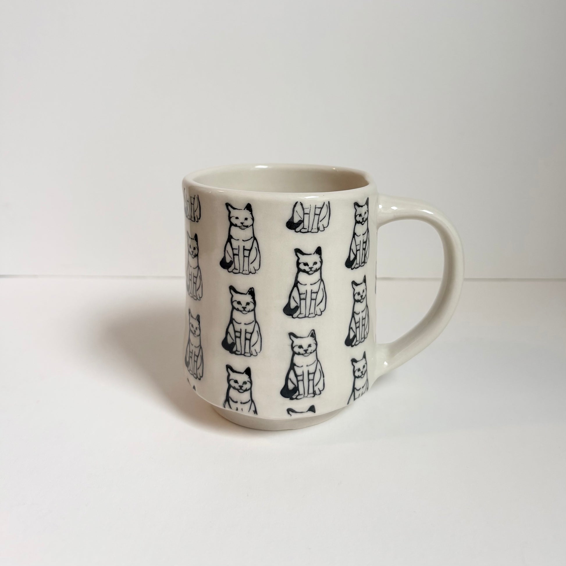 White mug with black cat designs