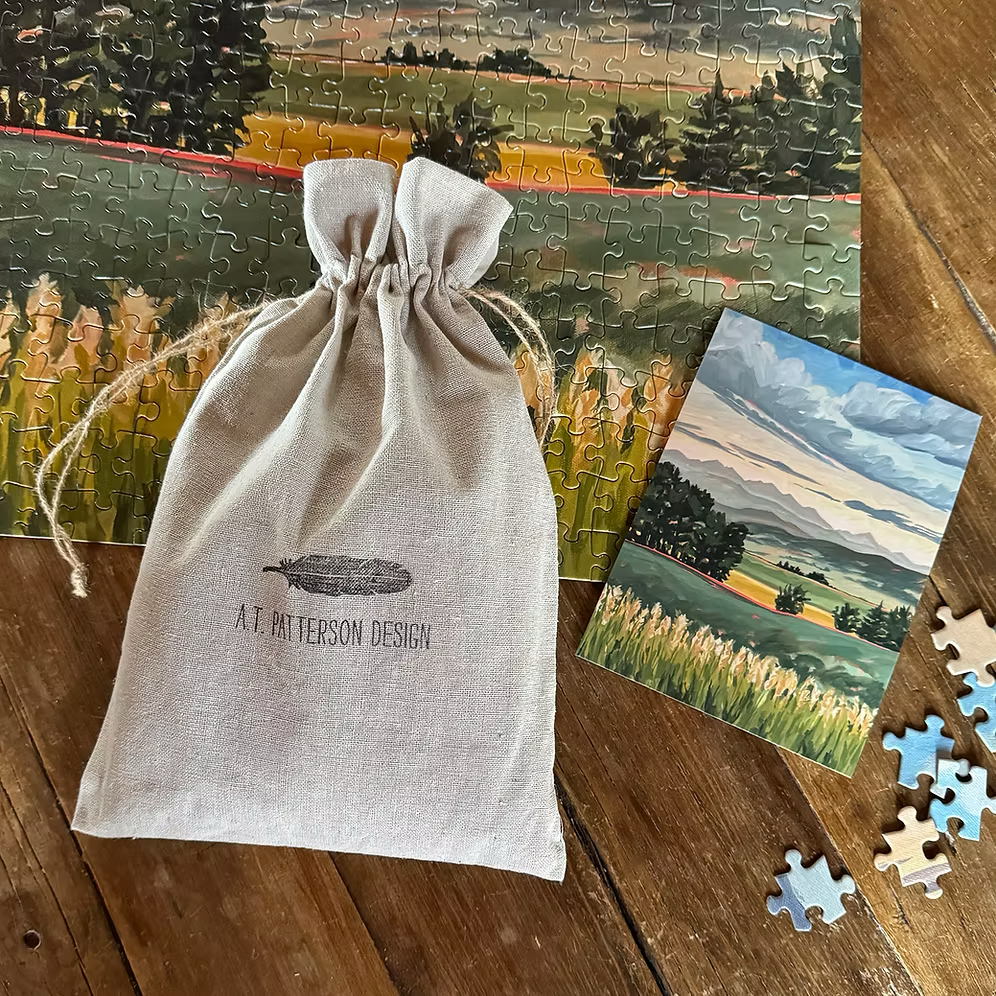 A.T. Patterson's puzzle featuring an original landscape art print.