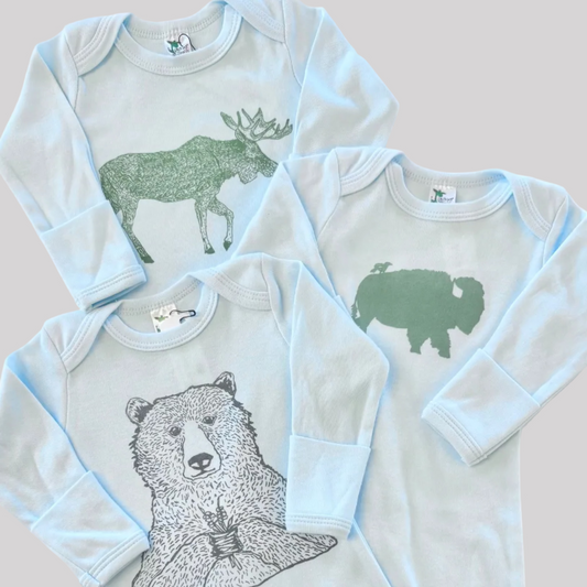 Bird and Buffalo’s baby gowns in blue featuring various designs, made locally in Jackson Hole, WY