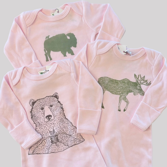 Bird and Buffalo’s baby gown in pink featuring various designs, made locally in Jackson Hole, WY