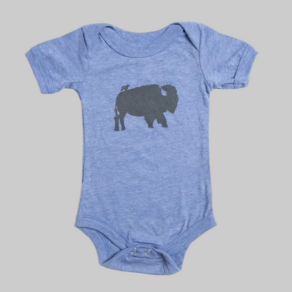 Bird and Buffalo’s baby onesie in blue with a bird and buffalo design, made locally in Jackson Hole, WY