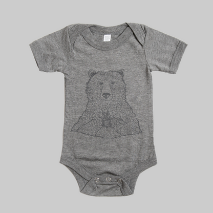 Bird and Buffalo’s baby onesie in gray with a bear holding flowers design, made locally in Jackson Hole, WY
