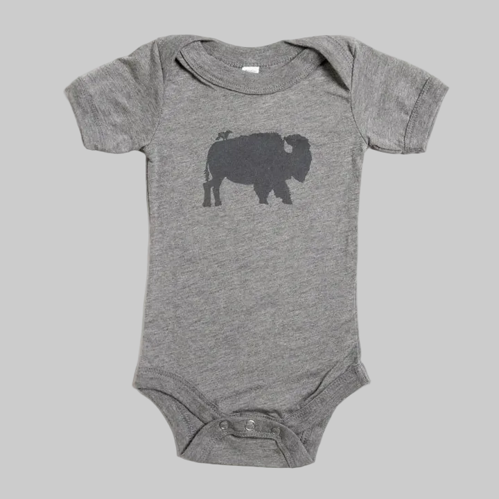 Bird and Buffalo’s baby onesie in gray with a bird and buffalo design, made locally in Jackson Hole, WY