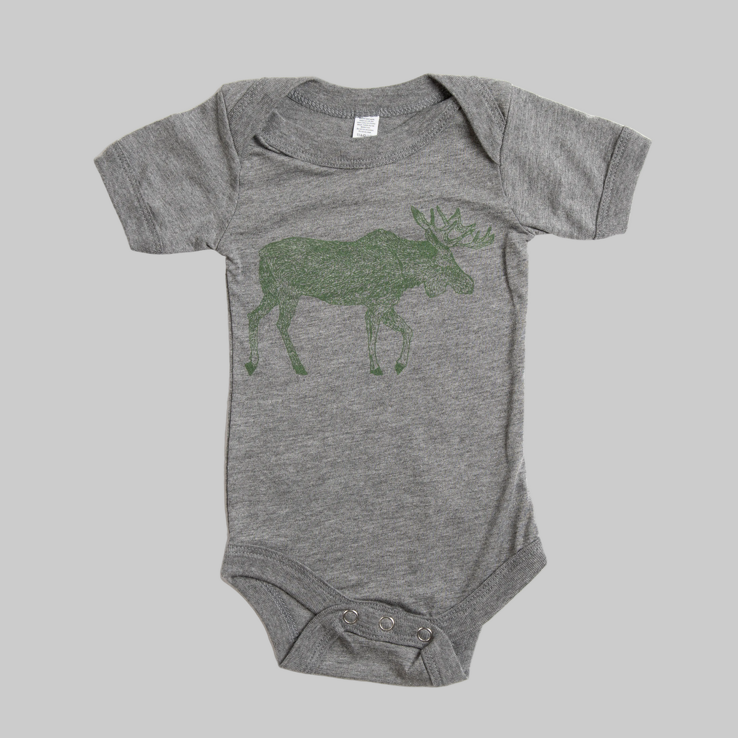 Bird and Buffalo’s baby onesie in gray with a green moose design, made locally in Jackson Hole, WY