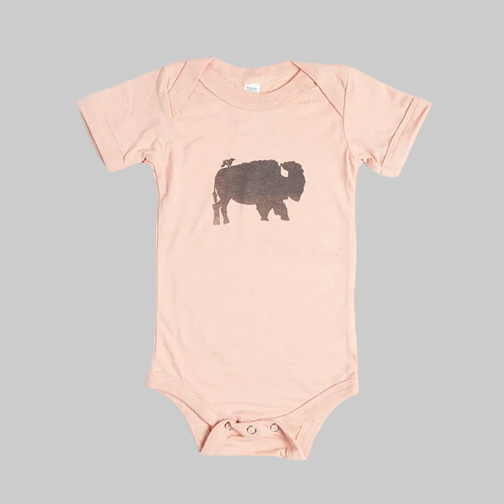 Bird and Buffalo’s baby onesie in pink with a bird and buffalo design, made locally in Jackson Hole, WY
