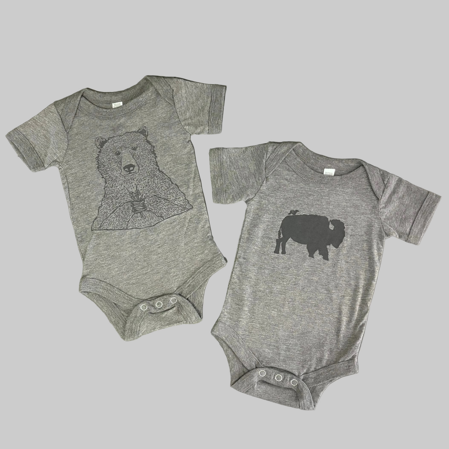 Bird and Buffalo’s baby onesie in gray with screen printed designs, made locally in Jackson Hole, WY