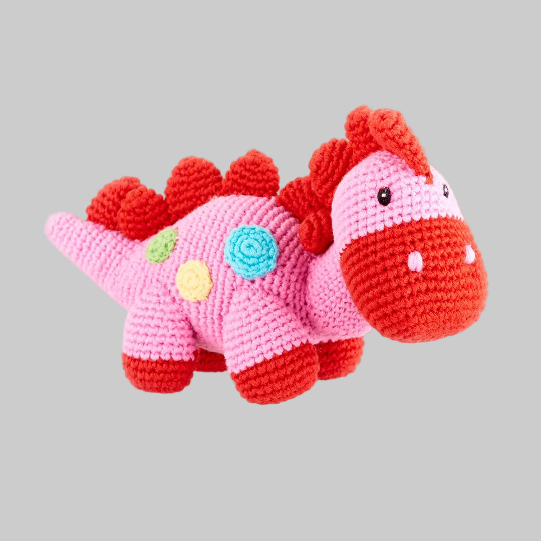 Hand-crocheted pink stegosaurus baby rattle made of 100% cotton