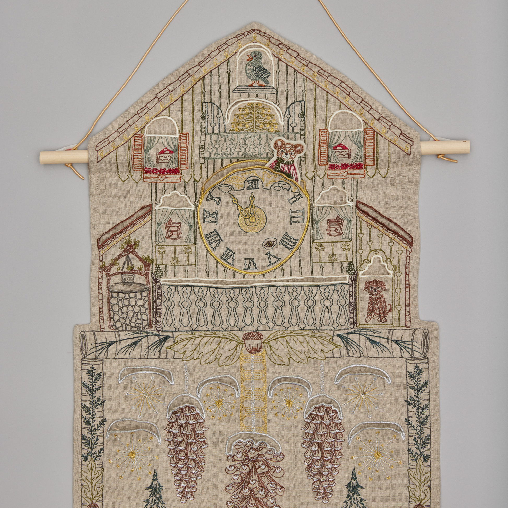 Coral and Tusk's "Christmas Clock" advent calendar featuring intricate embroidery and pockets for small gifts
