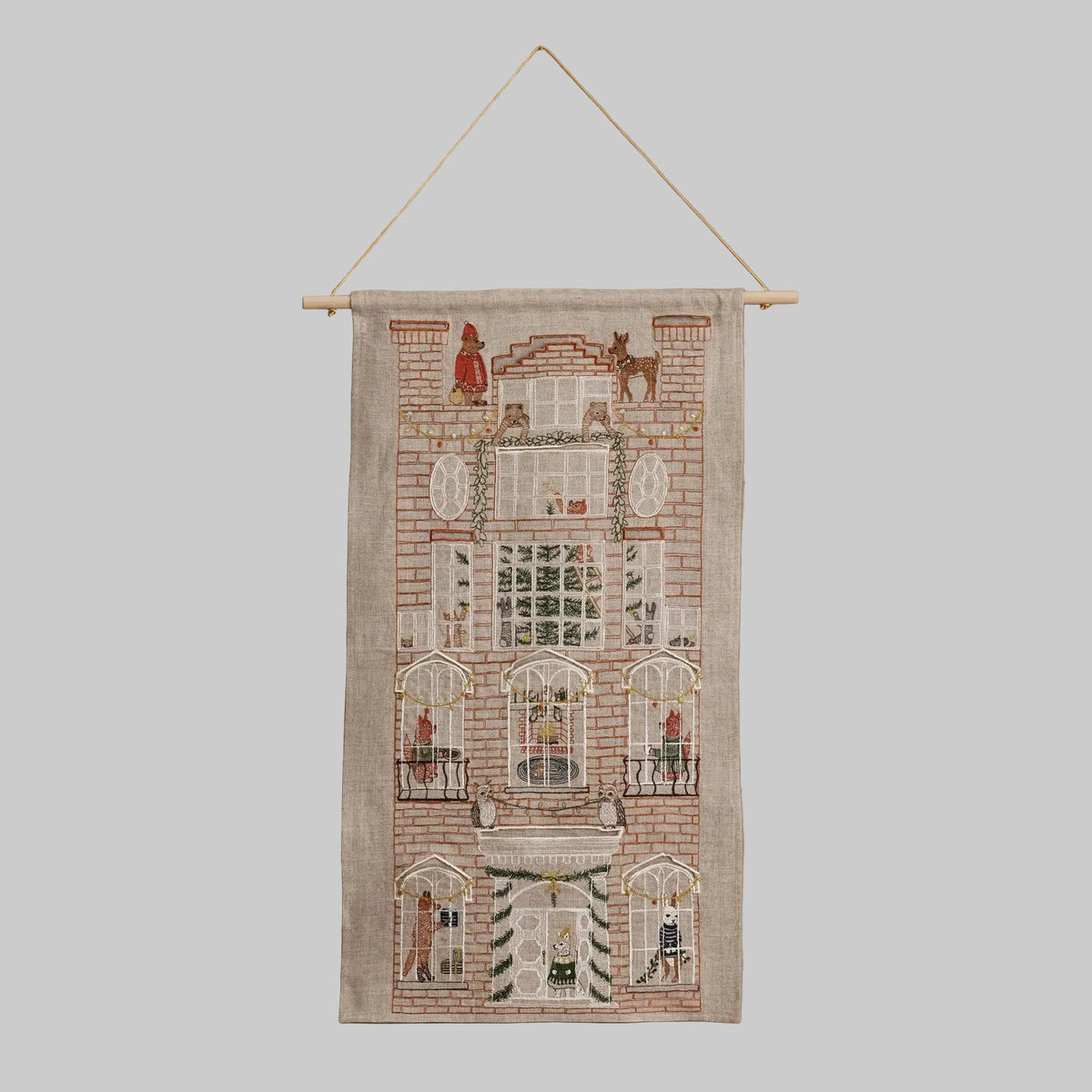 Coral and Tusk's "Holiday House" advent calendar featuring intricate embroidery and pockets for small gifts