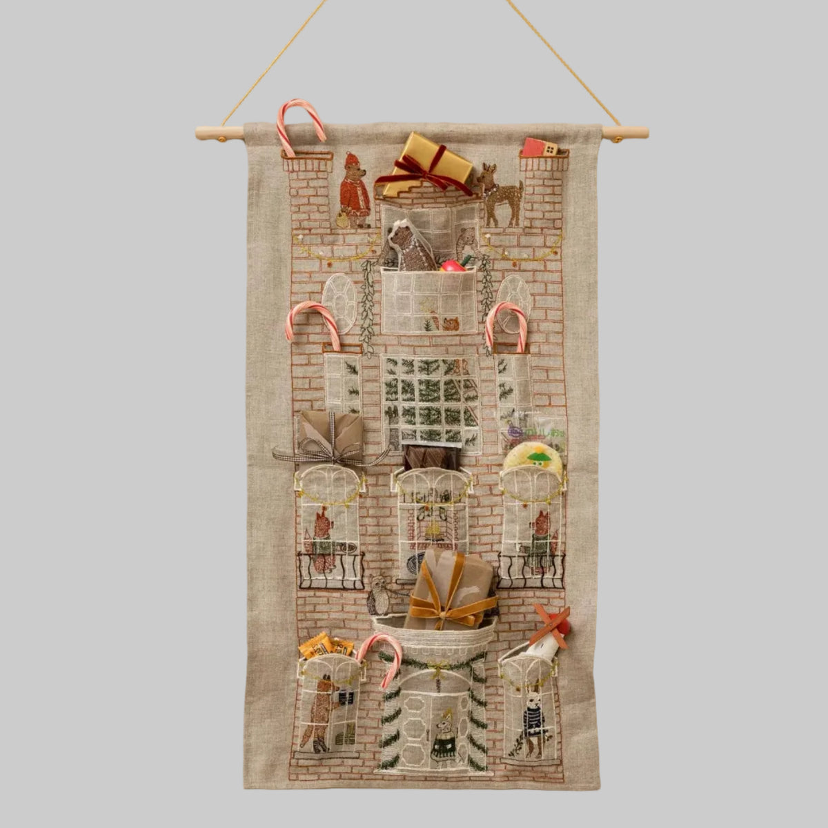 Coral and Tusk's "Holiday House" advent calendar featuring intricate embroidery and pockets for small gifts