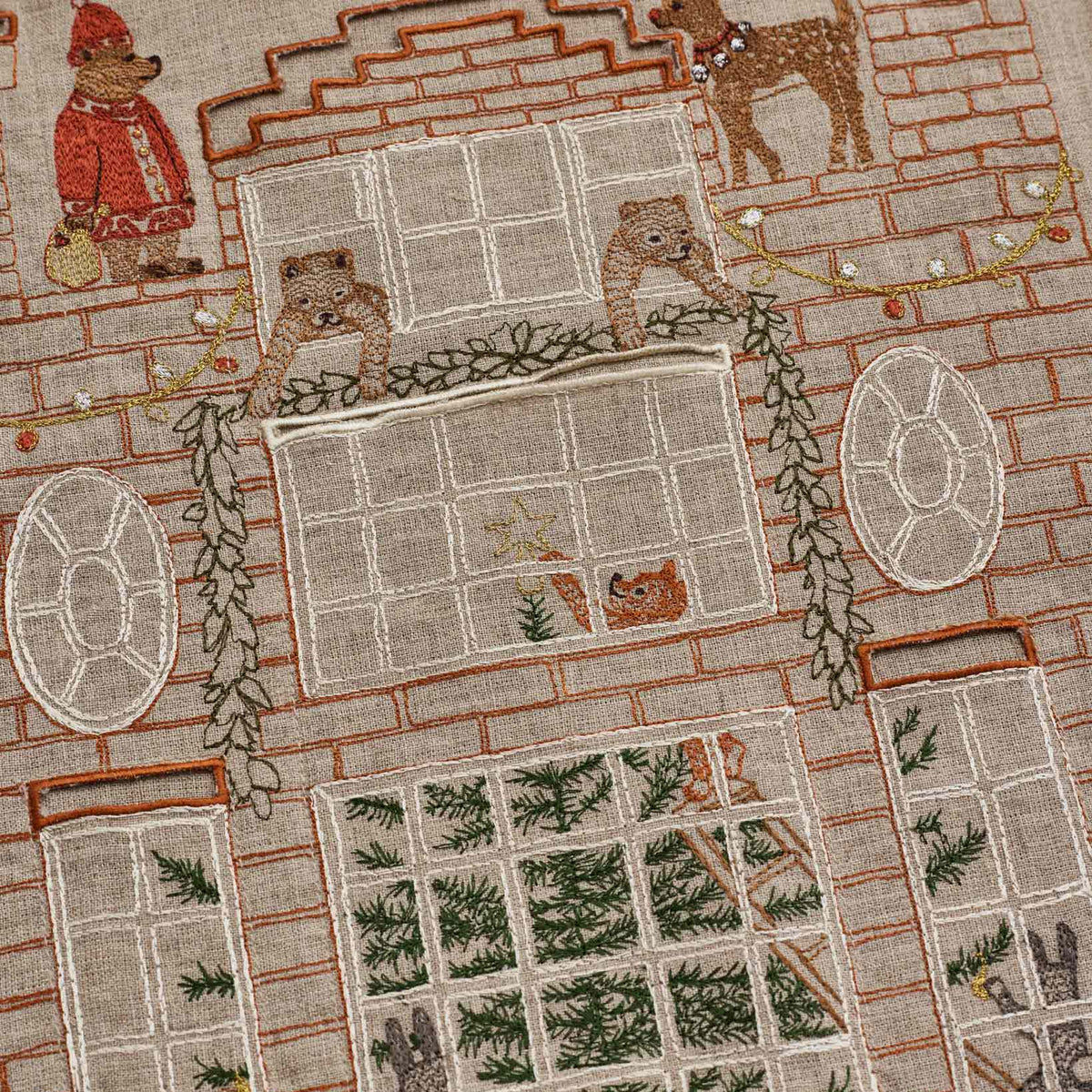 Coral and Tusk's "Holiday House" advent calendar featuring intricate embroidery and pockets for small gifts