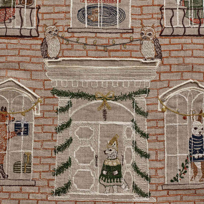 Coral and Tusk's "Holiday House" advent calendar featuring intricate embroidery and pockets for small gifts