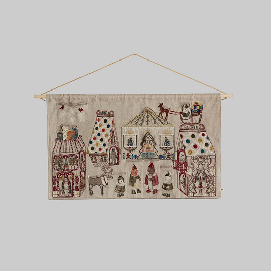 Coral and Tusk's "North Pole" advent calendar featuring intricate embroidery and pockets for small gifts