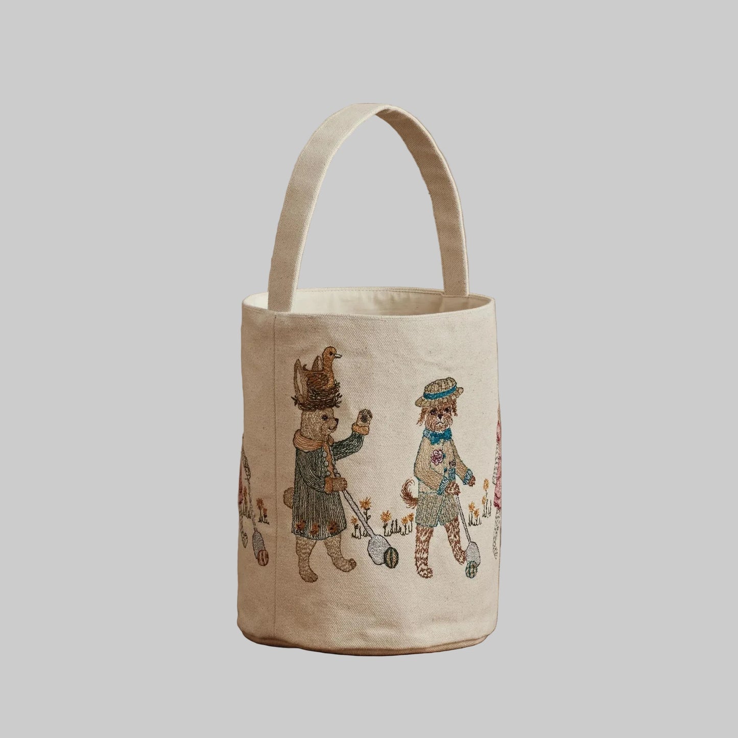 Coral and Tusk’s “Easter Egg Roll” embroidered canvas bag, featuring animals in vintage clothing rolling Easter eggs