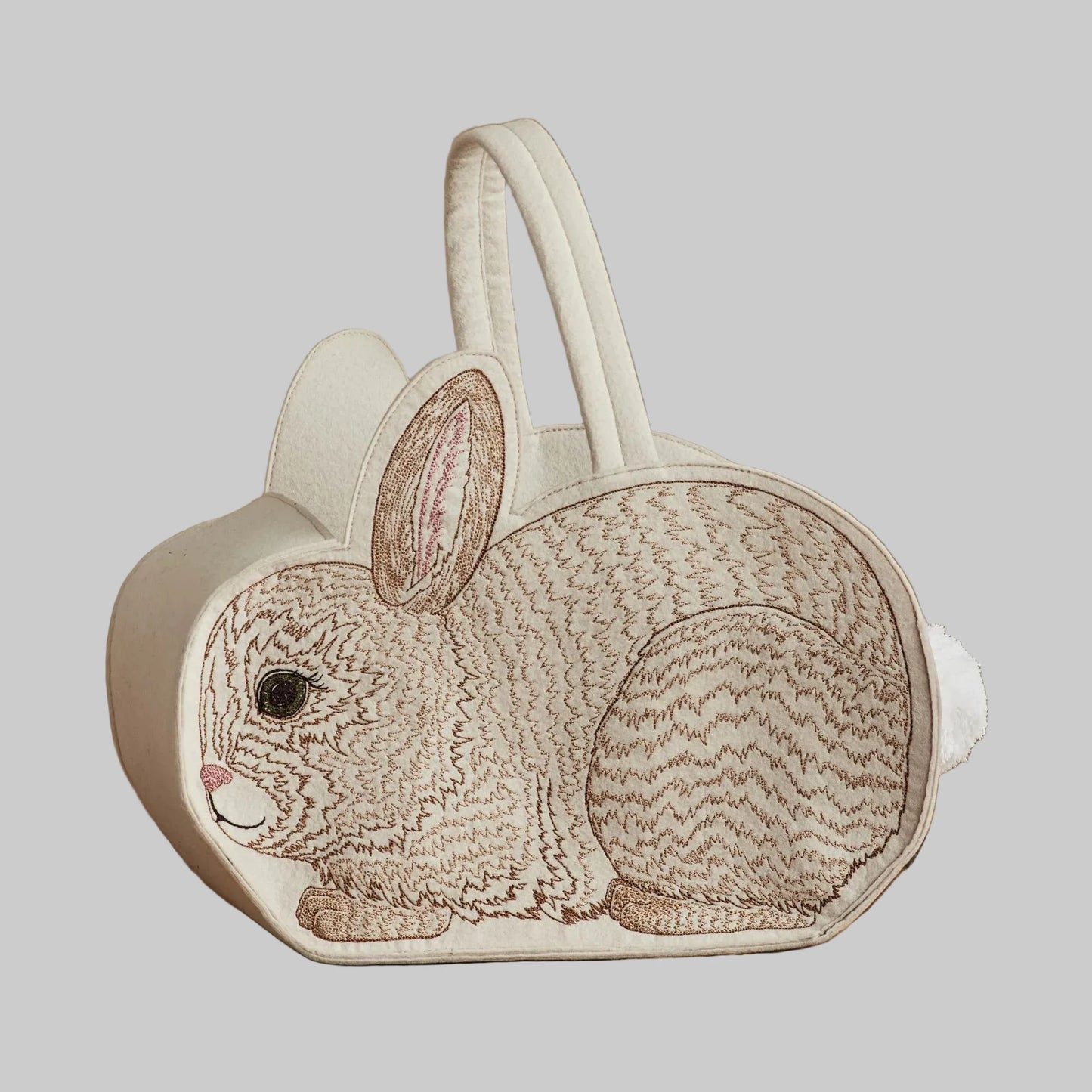 Coral and Tusk’s “Bunny” embroidered felt Easter basket, shaped like a bunny with a white cotton tail
