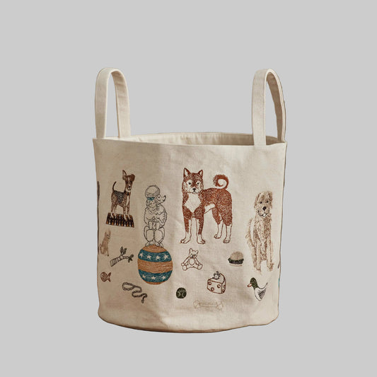 Coral and Tusk’s “Dog Toy” embroidered canvas bucket featuring designs of dogs and their toys