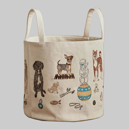 Coral and Tusk’s “Dog Toy” embroidered canvas bucket featuring designs of dogs and their toys