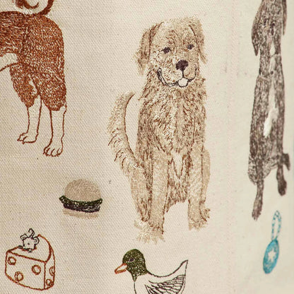 Coral and Tusk’s “Dog Toy” embroidered canvas bucket featuring designs of dogs and their toys
