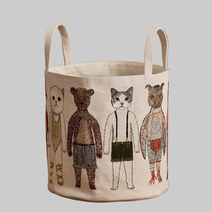 Coral and Tusk's "Pocket Doll" canvas bucket bag featuring embroidered designs of animal friends in fanciful clothing
