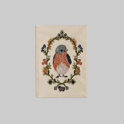 Coral and Tusk's "Baby Bluebird" embroidered keepsake card featuring a baby bird surrounded by a delicate wreath